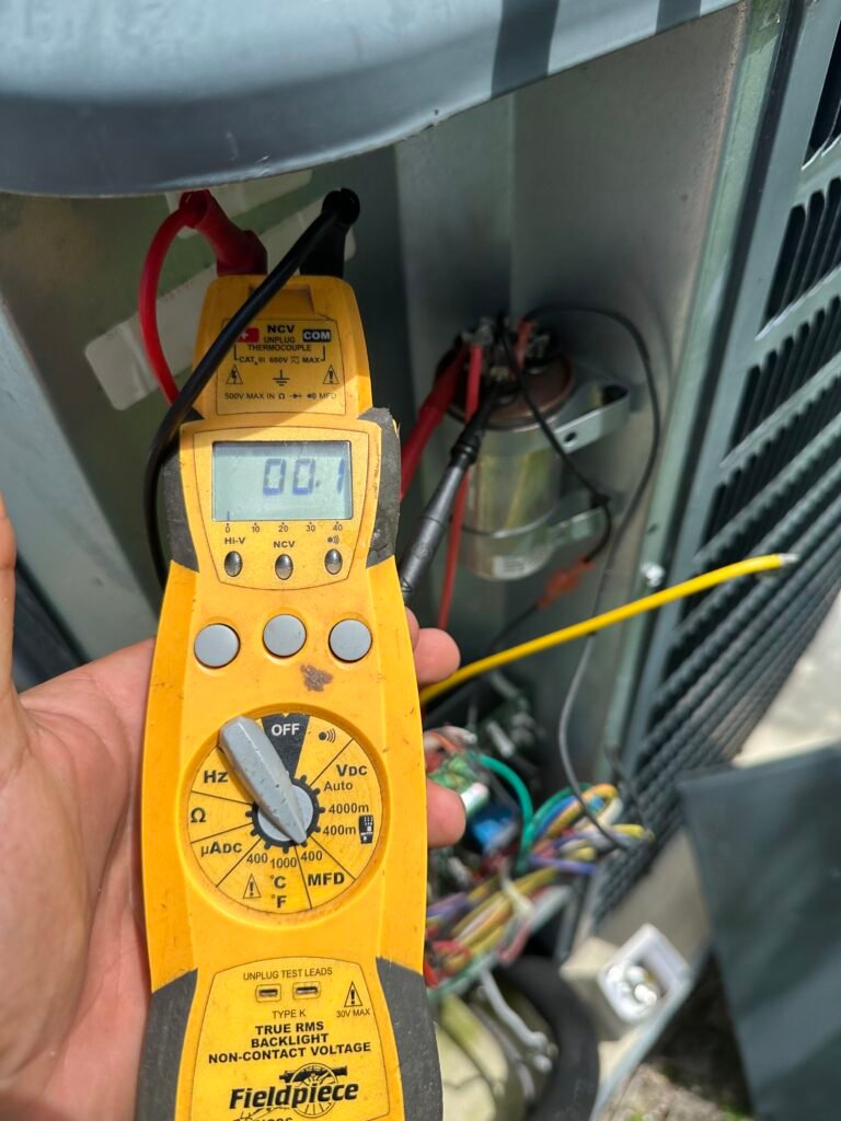 a hand holding a yellow device